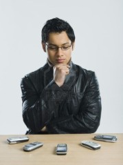 10167481-man-looking-at-mobile-phones-and-thinking