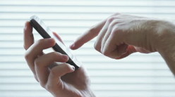 stock-footage-close-up-of-man-typing-on-touchpad-mobile-phone-with-his-fingers